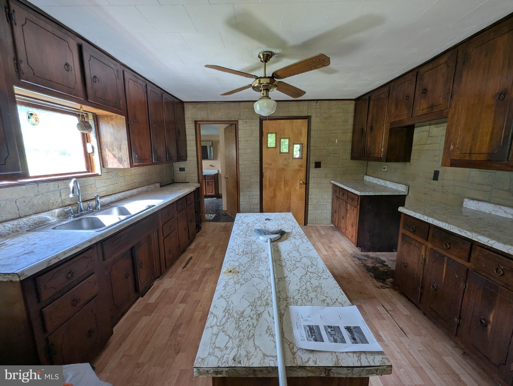 24001 Perry Hill Road Barton, MD 21521 - Photo 22 of 37 a large kitchen with kitchen island a stove a sink dishwasher and wooden cabinets