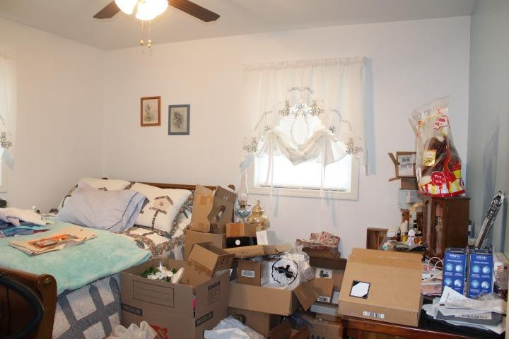 2431 South Toto Road North Judson, IN 46366 - Photo 13 of 25 a bed room with a bed and a chandelier