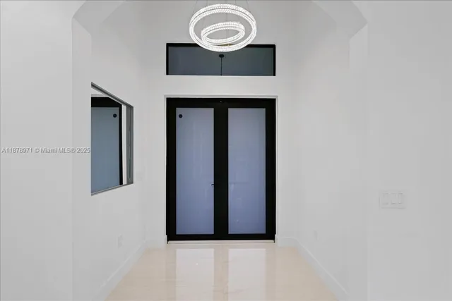 a view of a hallway with wooden cabinets