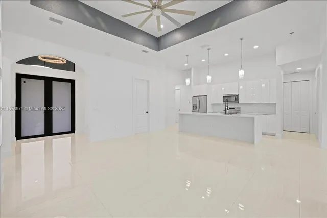 a view of a kitchen with a sink and a refrigerator