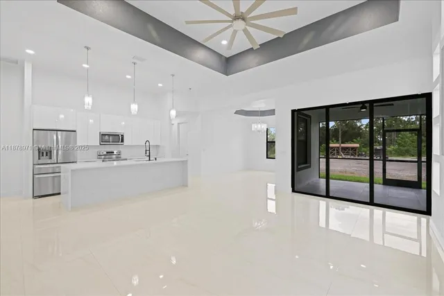 a large white kitchen with a large window