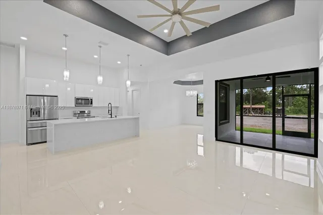 a large white kitchen with a large window