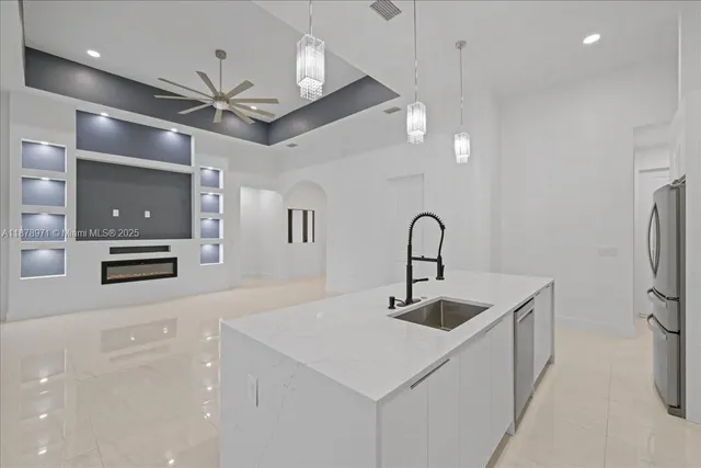 a kitchen with stainless steel appliances a sink and a refrigerator