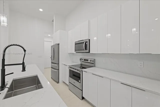 a kitchen with a sink appliances and cabinets