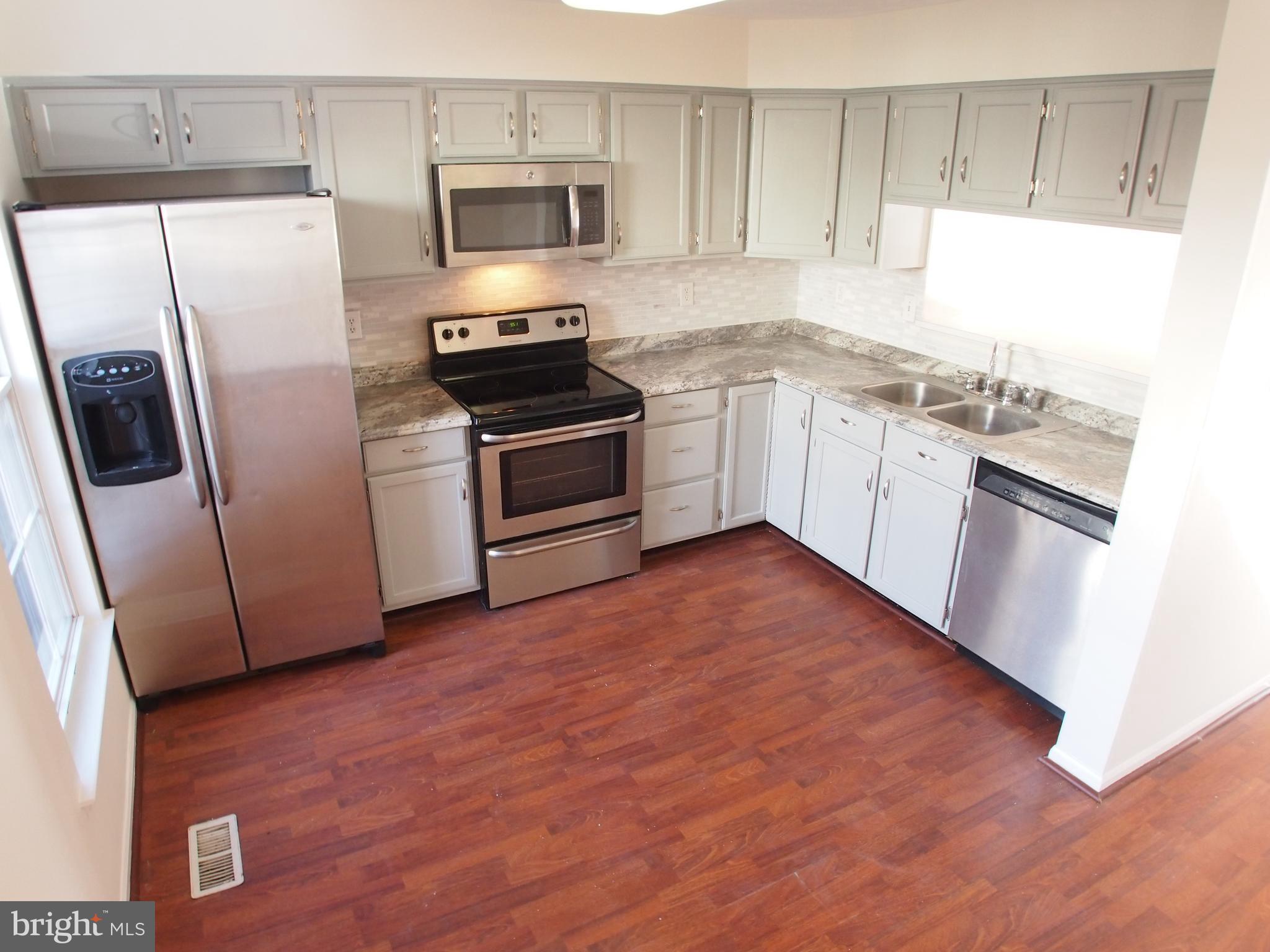 5307 Hollowstone Circle Rosedale, MD 21237 - Photo 2 of 22 a kitchen with stainless steel appliances a refrigerator sink and microwave
