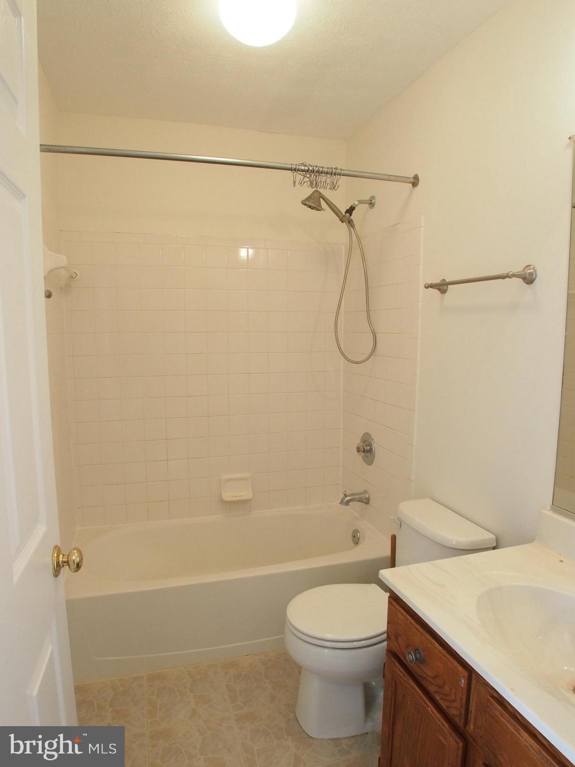5307 Hollowstone Circle Rosedale, MD 21237 - Photo 15 of 22 a bathroom with a granite countertop sink toilet and shower
