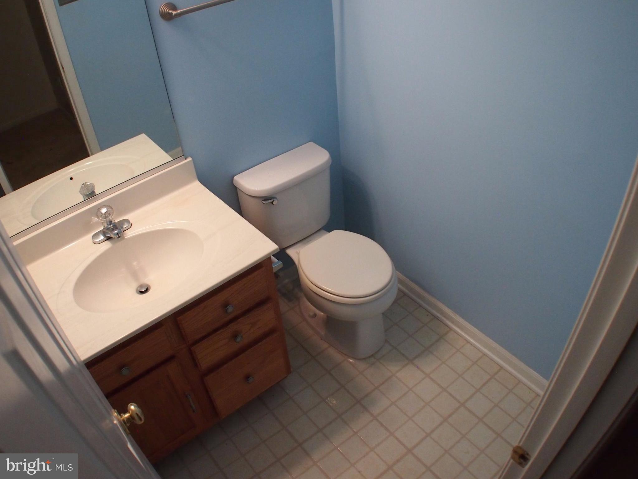 5307 Hollowstone Circle Rosedale, MD 21237 - Photo 18 of 22 a bathroom with a sink toilet and mirror