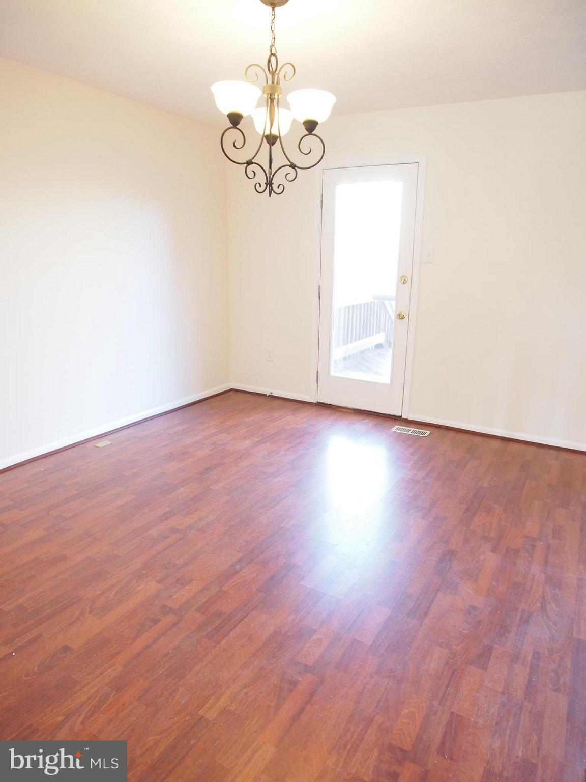 5307 Hollowstone Circle Rosedale, MD 21237 - Photo 3 of 22 a view of an empty room with wooden floor and windows
