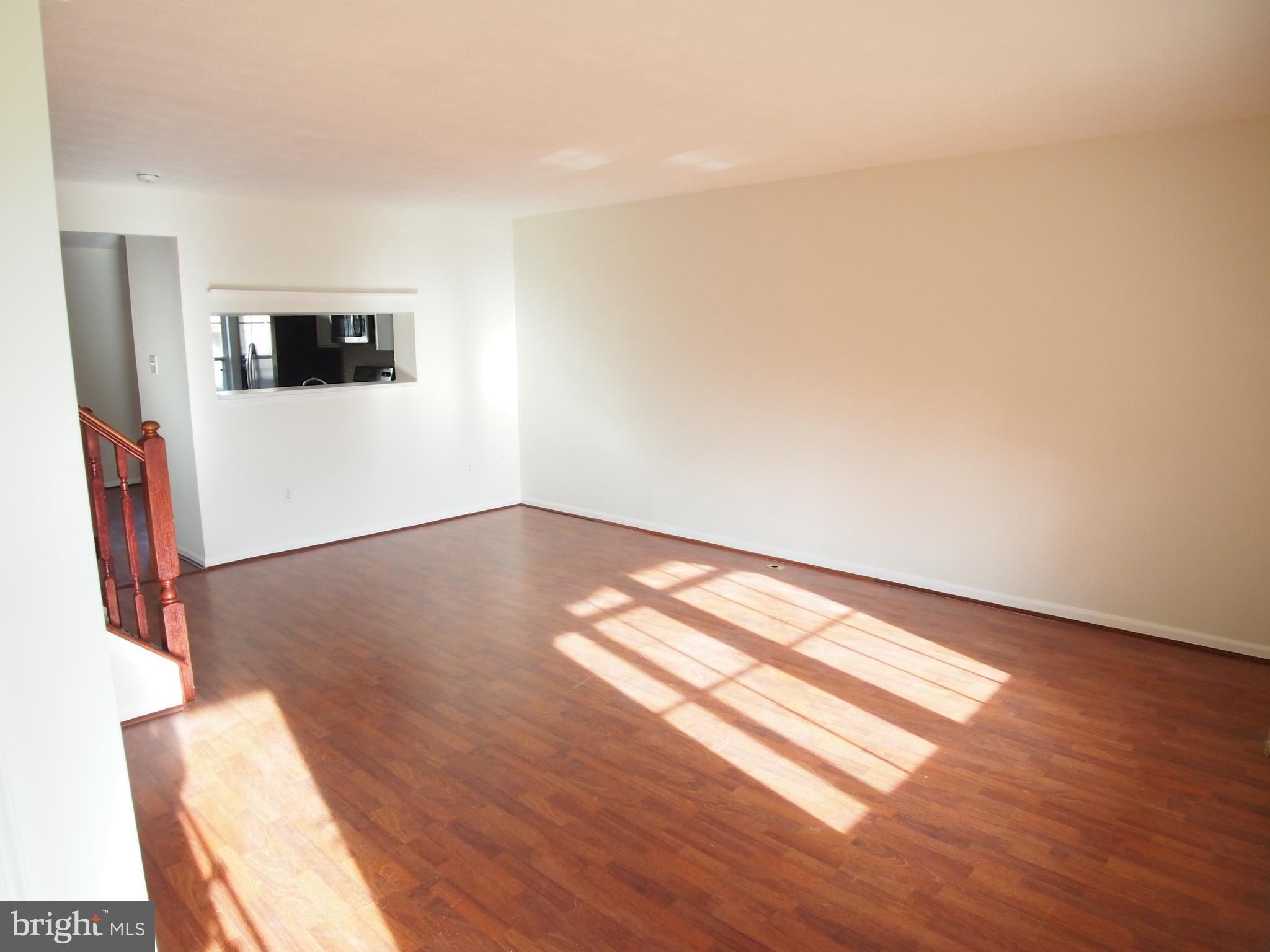 5307 Hollowstone Circle Rosedale, MD 21237 - Photo 6 of 22 a view of empty room with wooden floor and fan