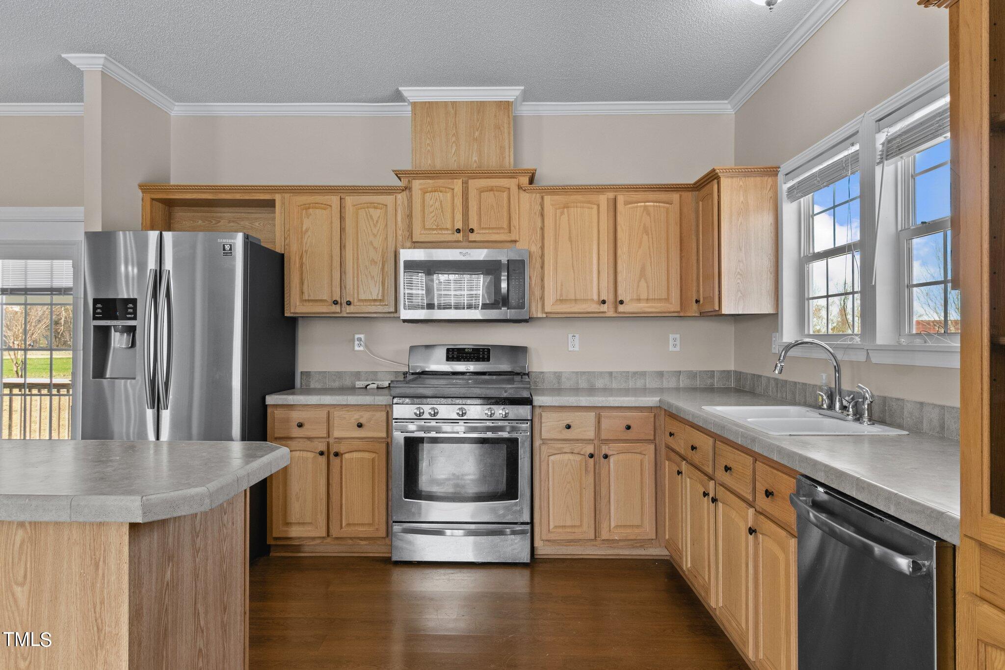 7929 Keener Road Clinton, NC 28328 - Photo 2 of 36 a kitchen with stainless steel appliances granite countertop a sink stove microwave and refrigerator