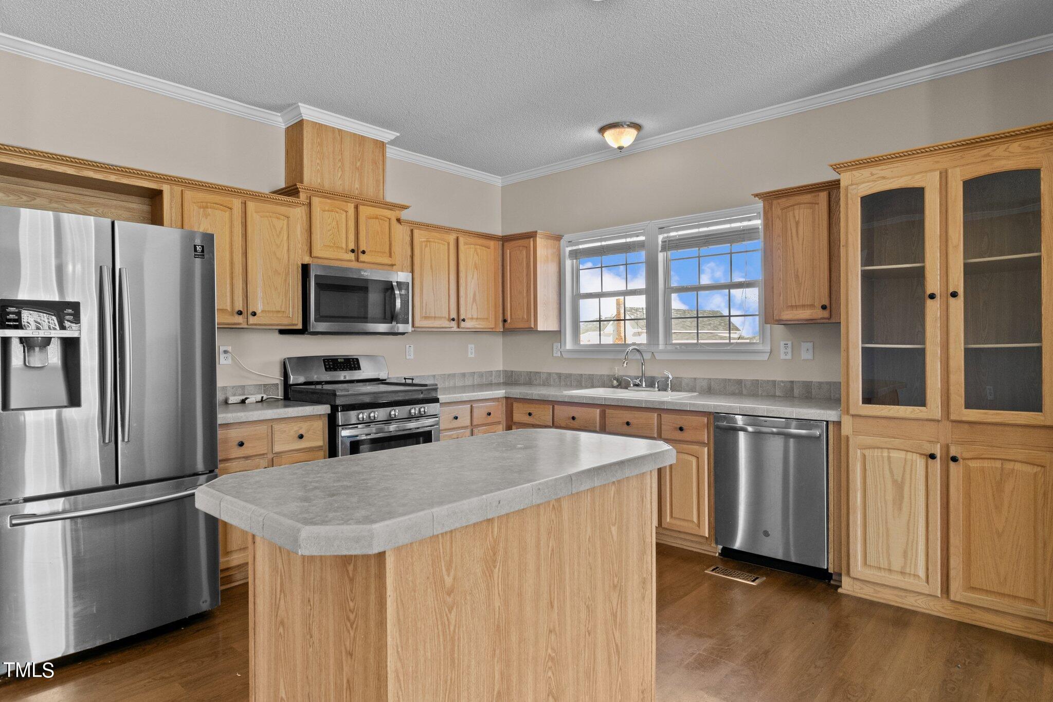 7929 Keener Road Clinton, NC 28328 - Photo 23 of 36 a kitchen with stainless steel appliances granite countertop a sink stove microwave and refrigerator