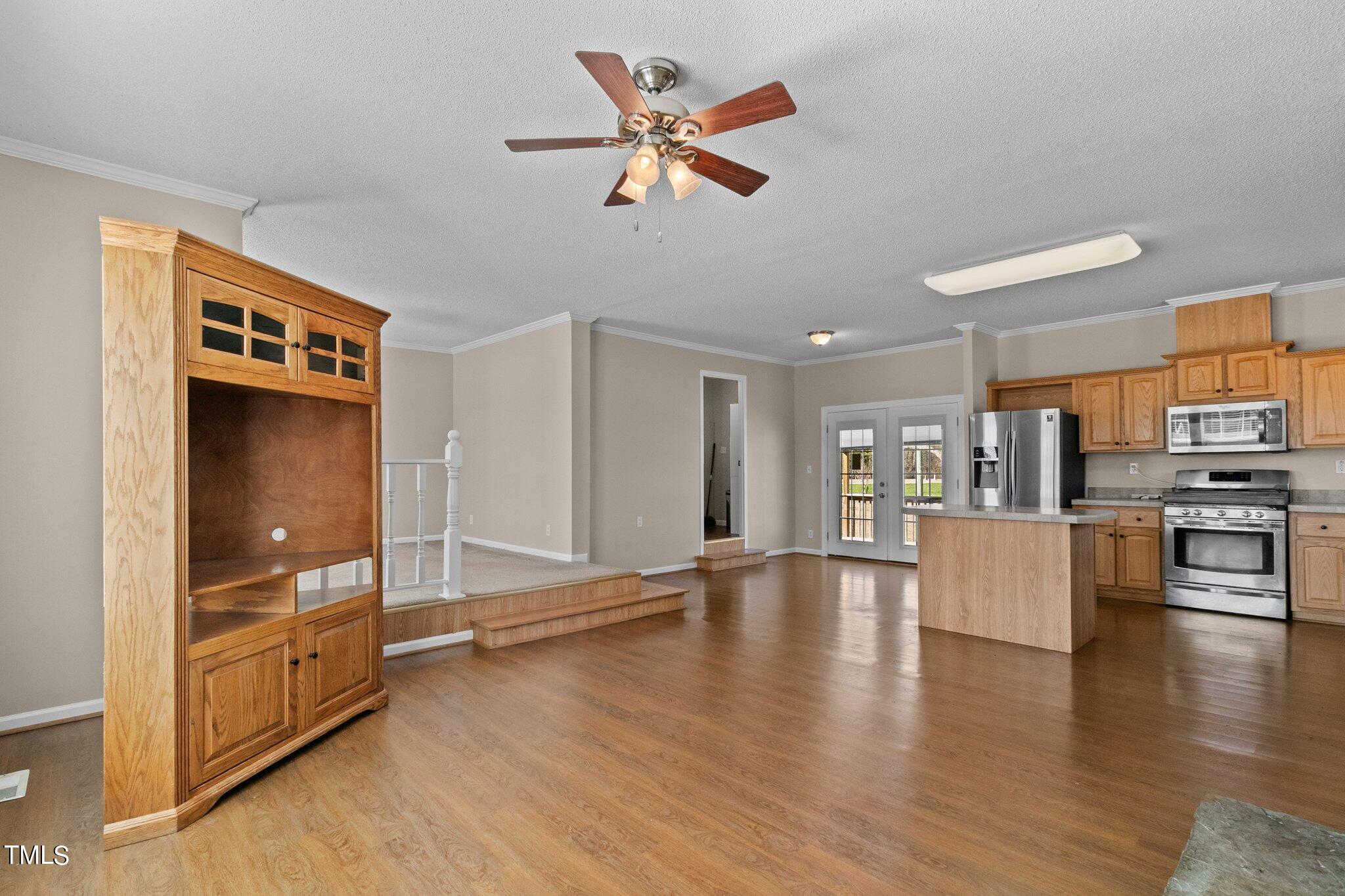 7929 Keener Road Clinton, NC 28328 - Photo 25 of 36 a view of an empty room and kitchen with wooden floor