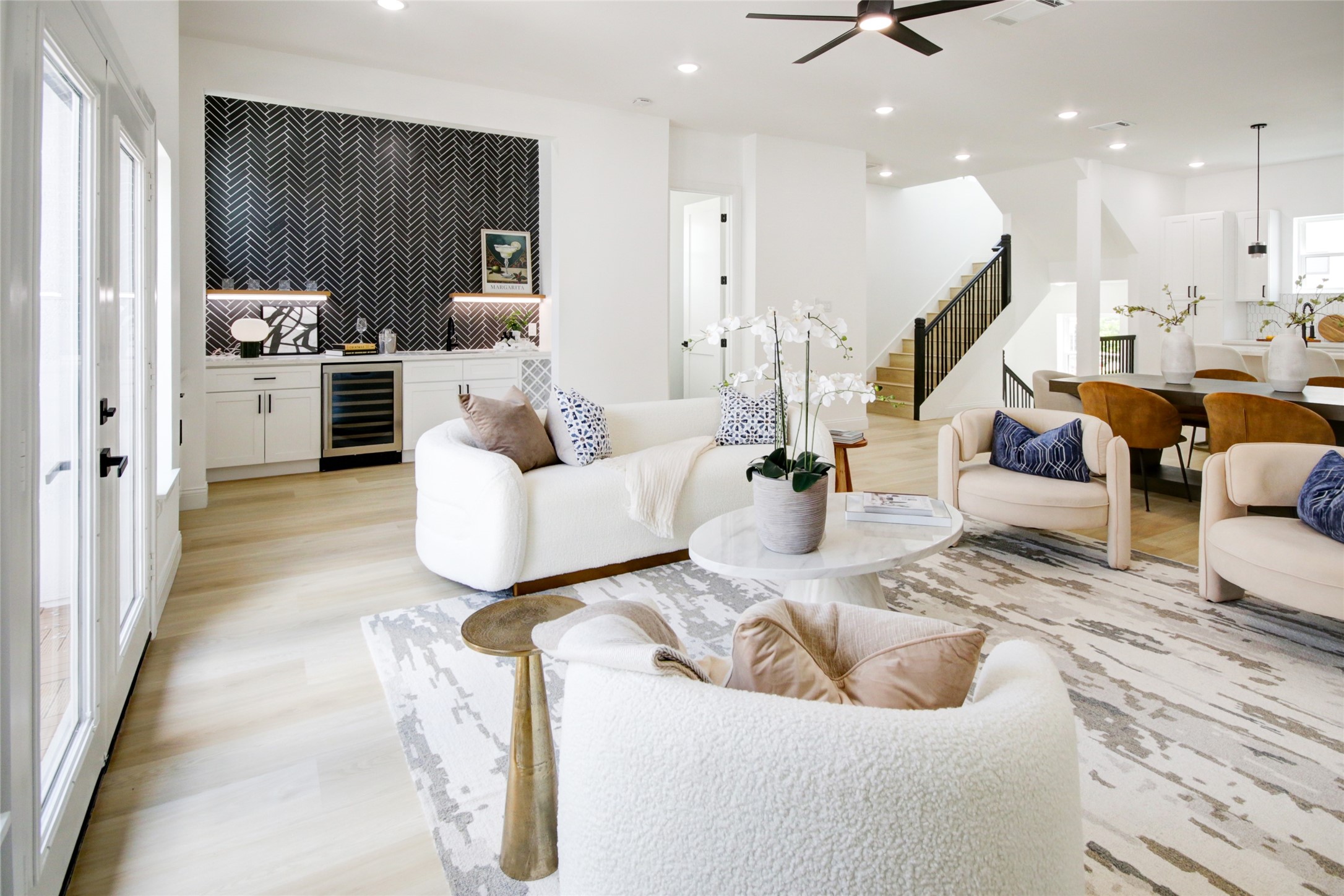 a living room with furniture and kitchen view