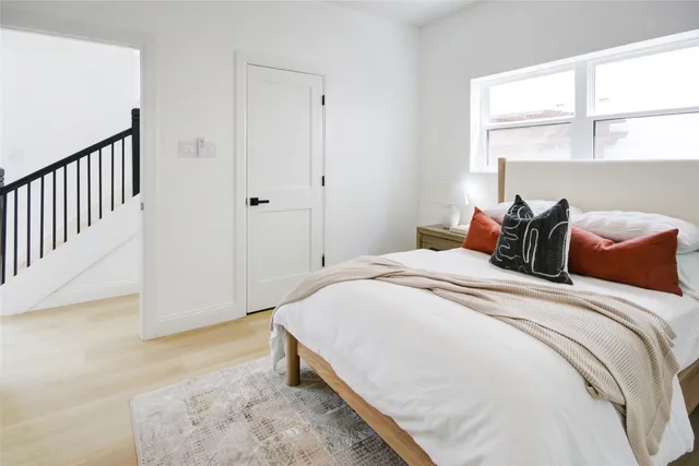 a bedroom with a bed and a window