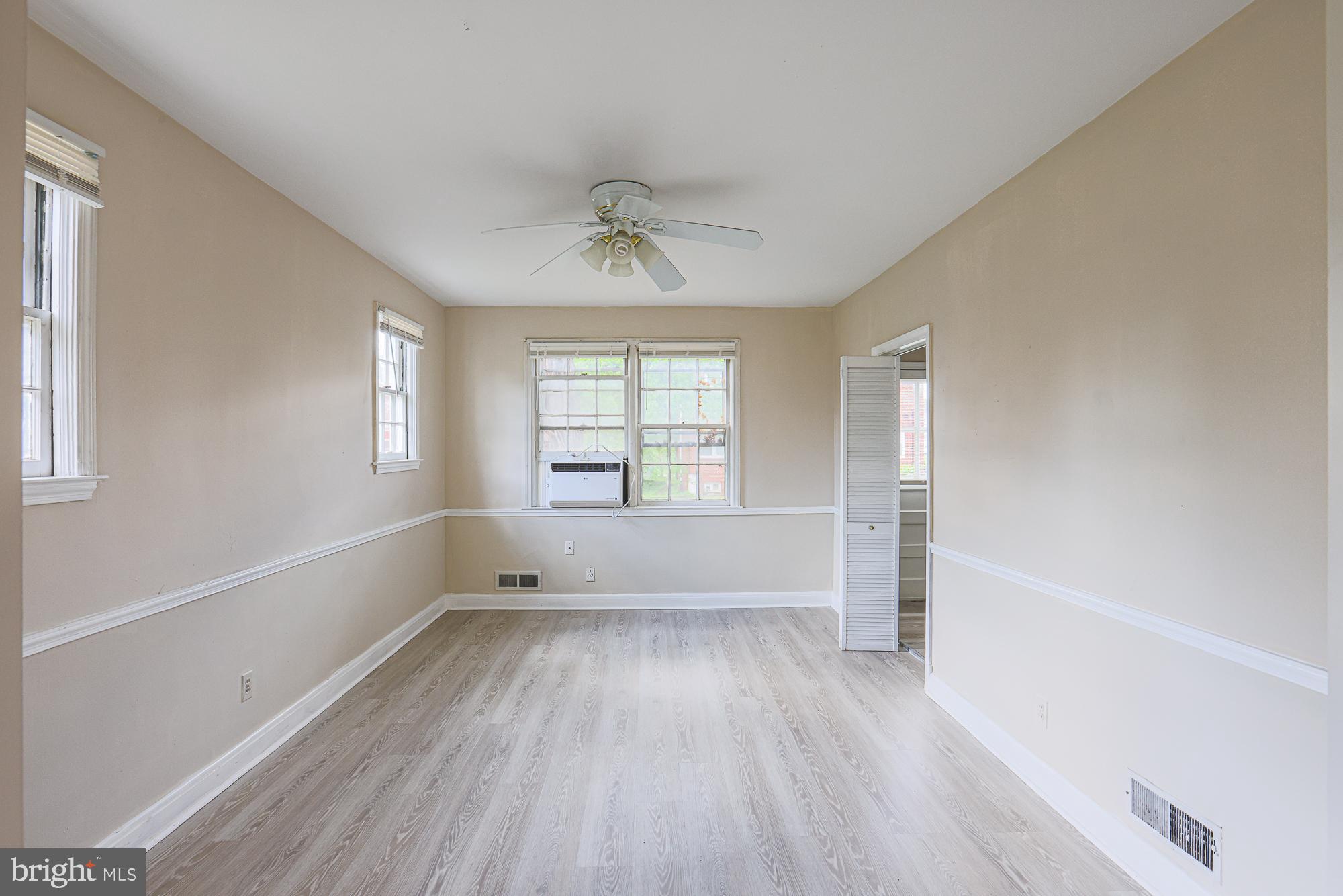 3914 Bancroft Road Baltimore, MD 21215 - Photo 8 of 25 a view of empty room with wooden floor and fan