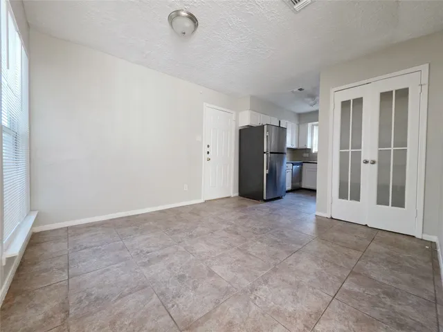 a view of a kitchen with refrigerator and microwave