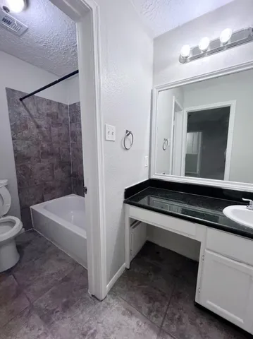 a bathroom with a sink a toilet and a bathtub