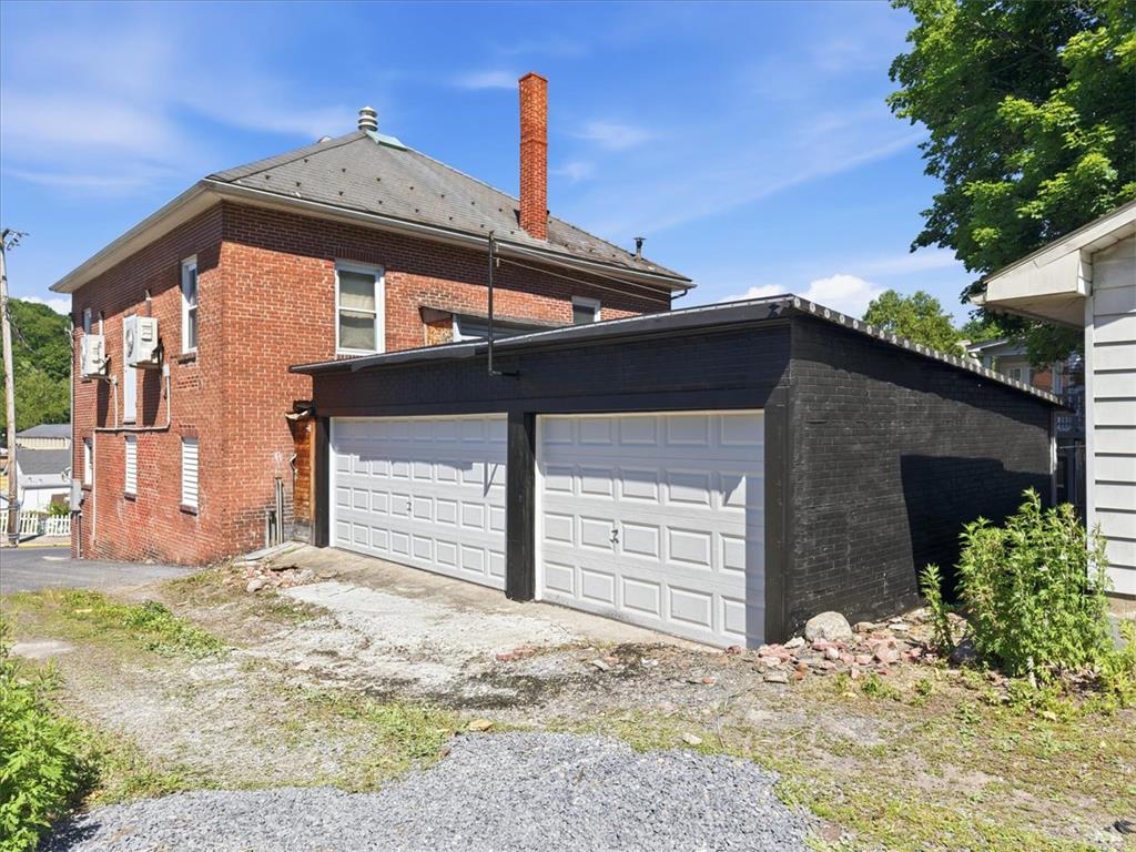 110 Messinger Street Bangor, PA 18013 - Photo 25 of 39 Two attached garages offer convenient vehicle storage, complementing the brick exterior of this charming residence.