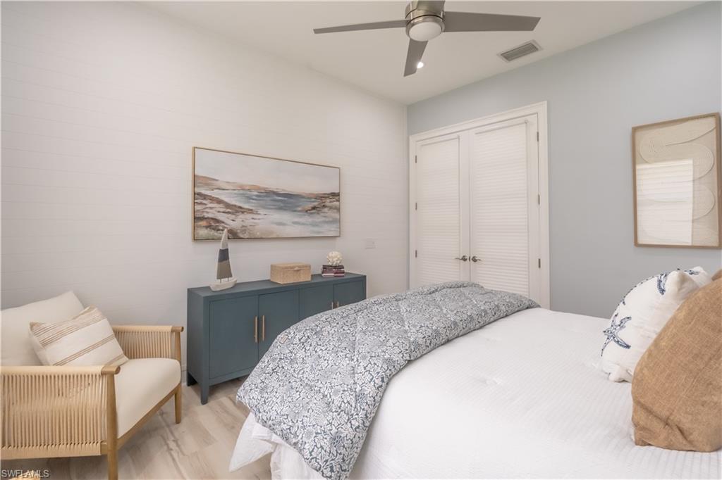 5060 Martinique Drive Naples, FL 34113 - Photo 33 of 49 An accent wall of ship lap brings in a subtle coastal vibe. French doors have custom blinds to provide privacy.