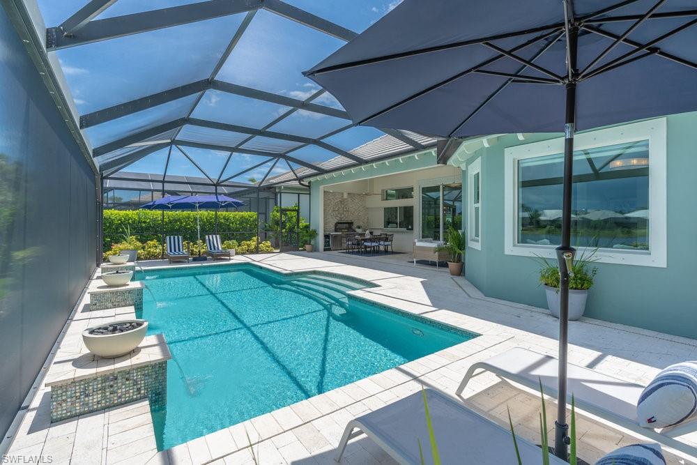 5060 Martinique Drive Naples, FL 34113 - Photo 41 of 49 Multiple gathering areas for relaxation are found under the huge panoramic screened-in lanai
