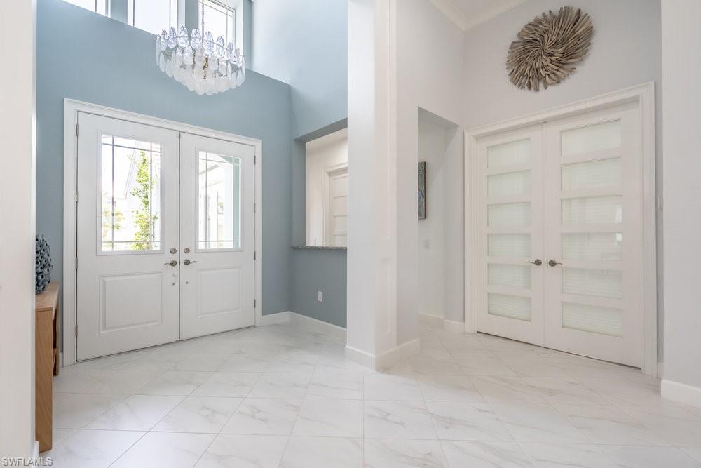 5060 Martinique Drive Naples, FL 34113 - Photo 10 of 49 double french doors open to a bedroom suite