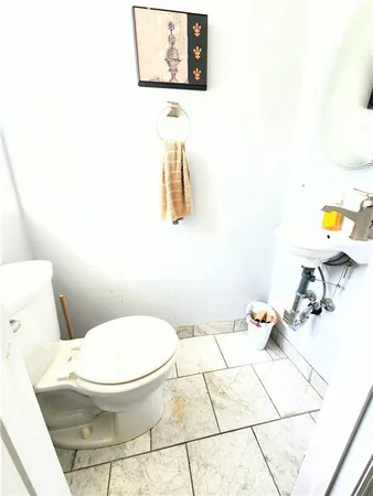 a white toilet sitting next to a bathroom sink