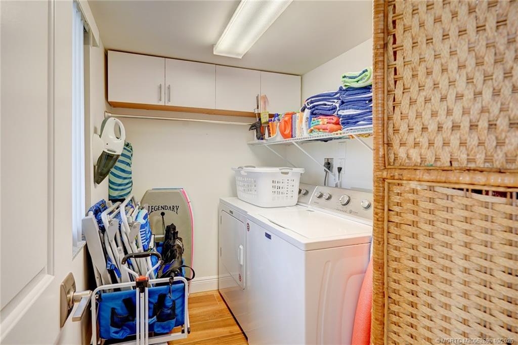 40 Northeast Plantation Road, Unit 203 Jensen Beach, FL 34957 - Photo 11 of 53 a utility room with dryer and washer