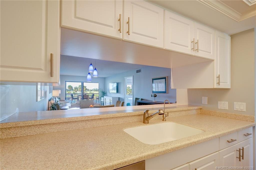 40 Northeast Plantation Road, Unit 203 Jensen Beach, FL 34957 - Photo 14 of 53 a kitchen with stainless steel appliances a sink and cabinets