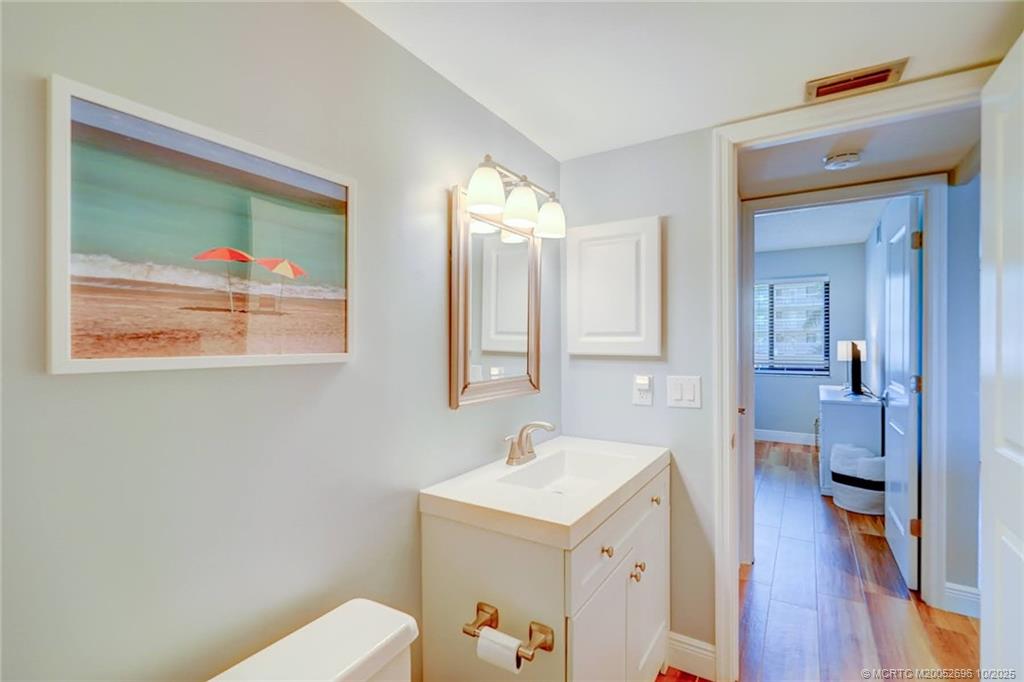 40 Northeast Plantation Road, Unit 203 Jensen Beach, FL 34957 - Photo 19 of 53 a bathroom with a sink a mirror and a toilet