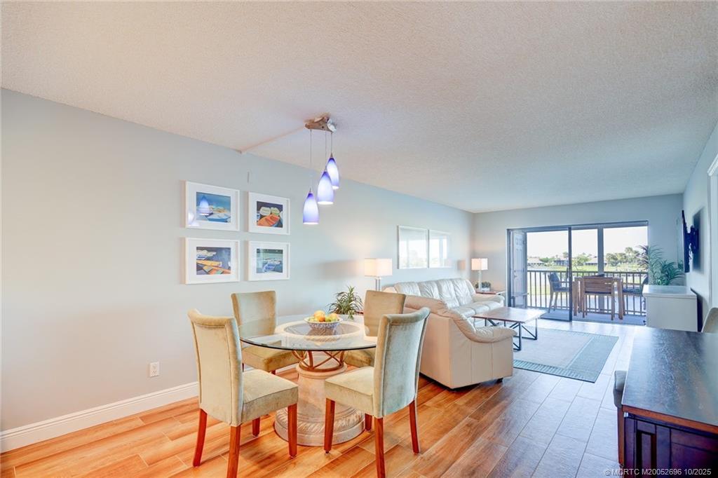 40 Northeast Plantation Road, Unit 203 Jensen Beach, FL 34957 - Photo 20 of 53 a view of a dining room with furniture and wooden floor