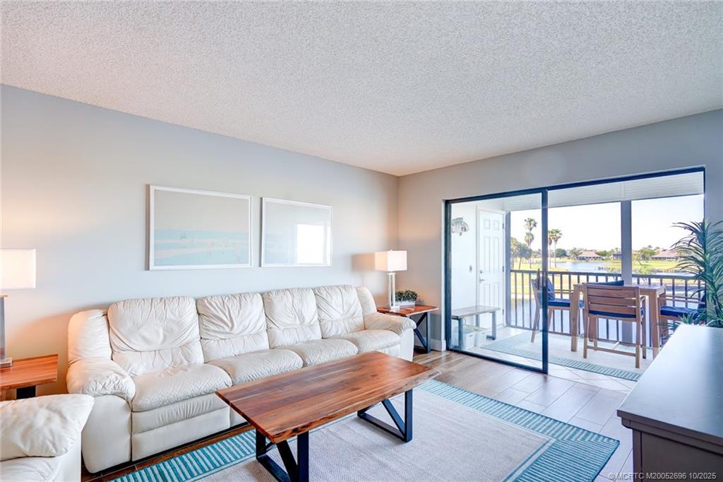 40 Northeast Plantation Road, Unit 203 Jensen Beach, FL 34957 - Photo 23 of 53 a living room with furniture and a large window