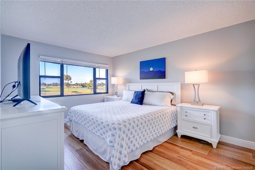 40 Northeast Plantation Road, Unit 203 Jensen Beach, FL 34957 - Photo 27 of 53 a bedroom with a bed and a dresser