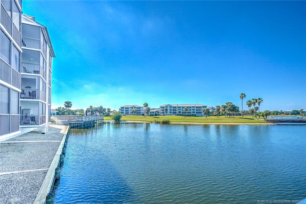 40 Northeast Plantation Road, Unit 203 Jensen Beach, FL 34957 - Photo 35 of 53 a view of outdoor space with swimming pool and lake view