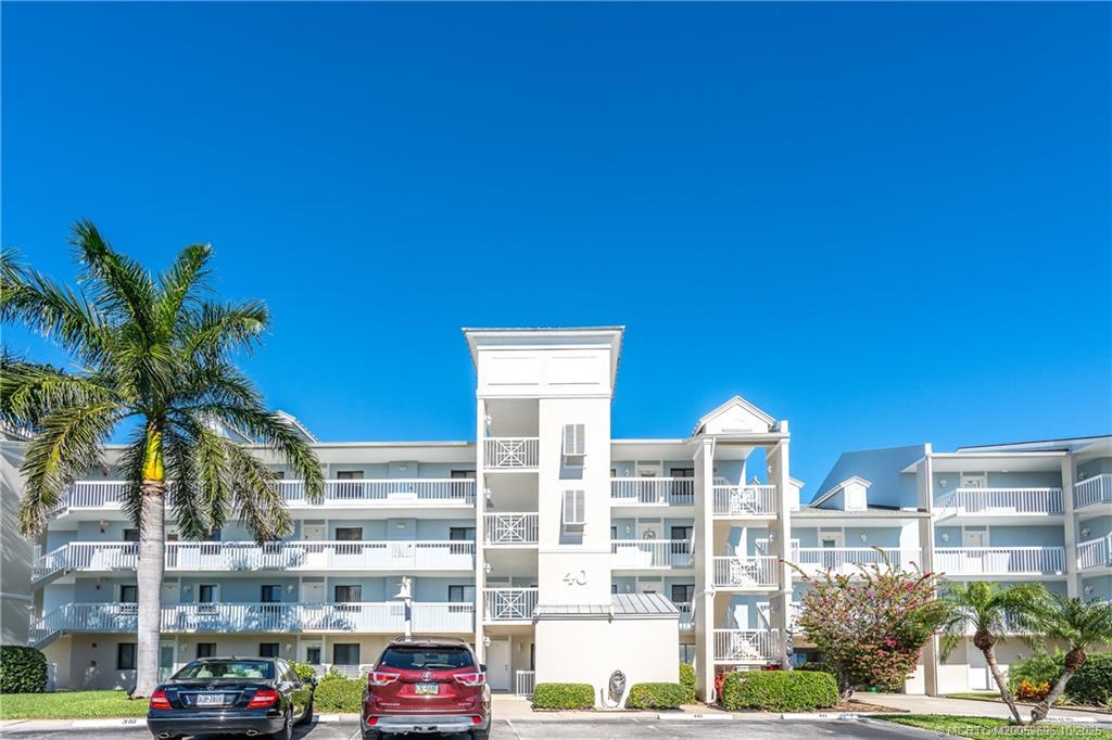 40 Northeast Plantation Road, Unit 203 Jensen Beach, FL 34957 - Photo 47 of 53 a front view of a building with palm trees