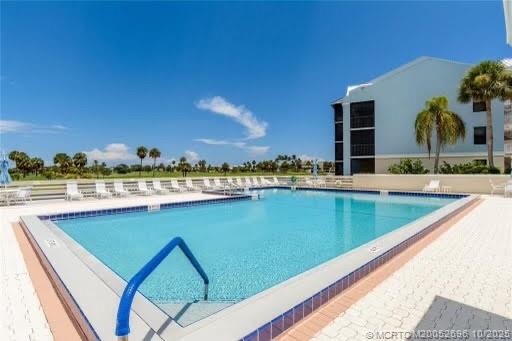 40 Northeast Plantation Road, Unit 203 Jensen Beach, FL 34957 - Photo 50 of 53 a view of swimming pool with outdoor seating and city view