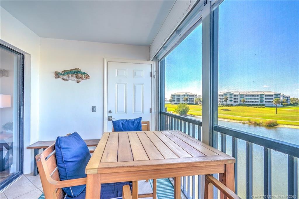 40 Northeast Plantation Road, Unit 203 Jensen Beach, FL 34957 - Photo 7 of 53 a bedroom with a bed and a lounge chair