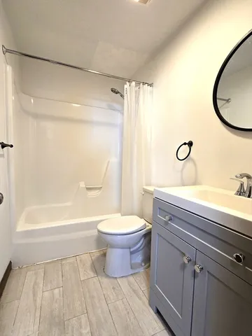 a bathroom with a toilet a sink and a bathtub