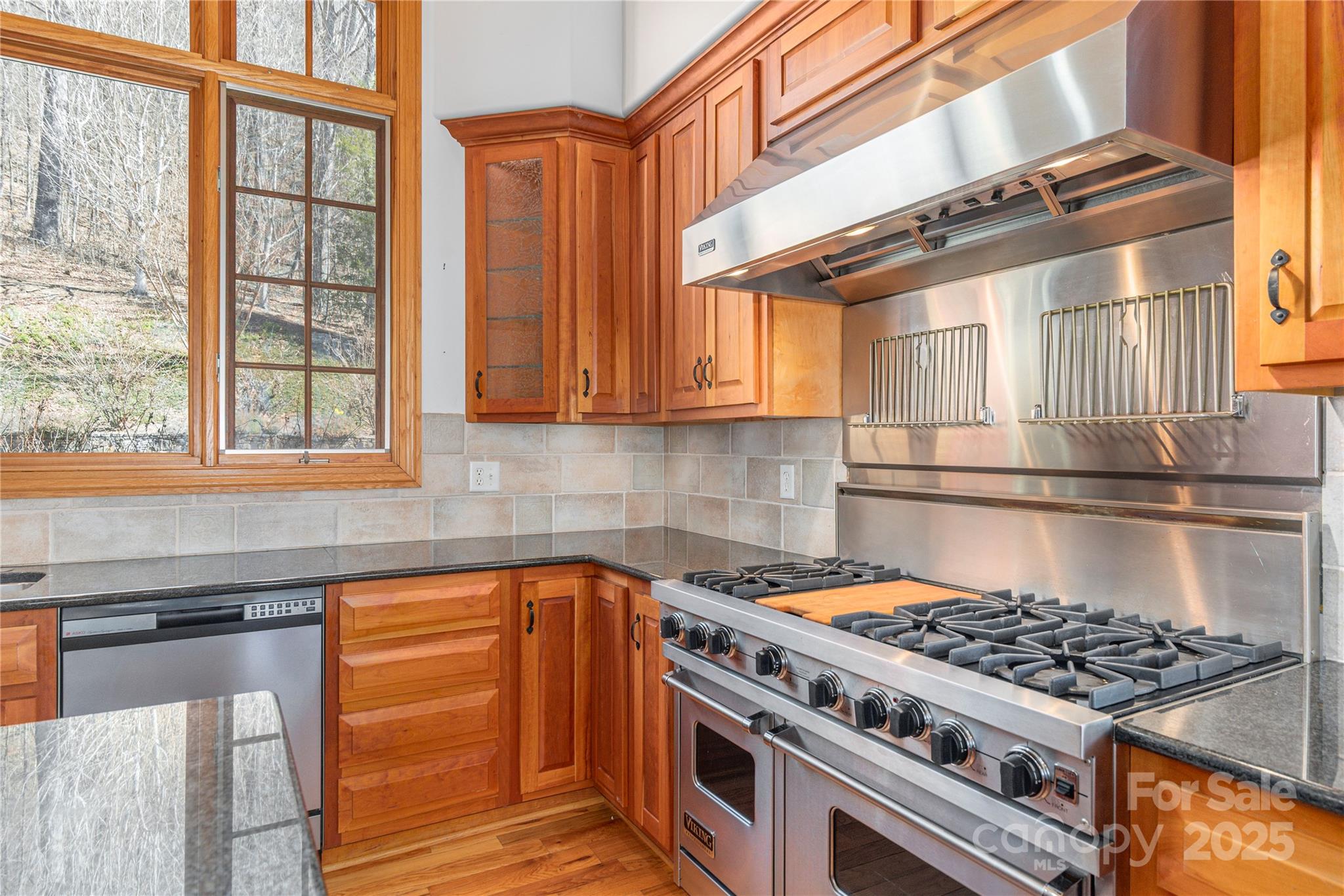 98 Flat Creek Road Fairview, NC 28730 - Photo 15 of 47 a kitchen with stainless steel appliances granite countertop a stove a sink and a microwave