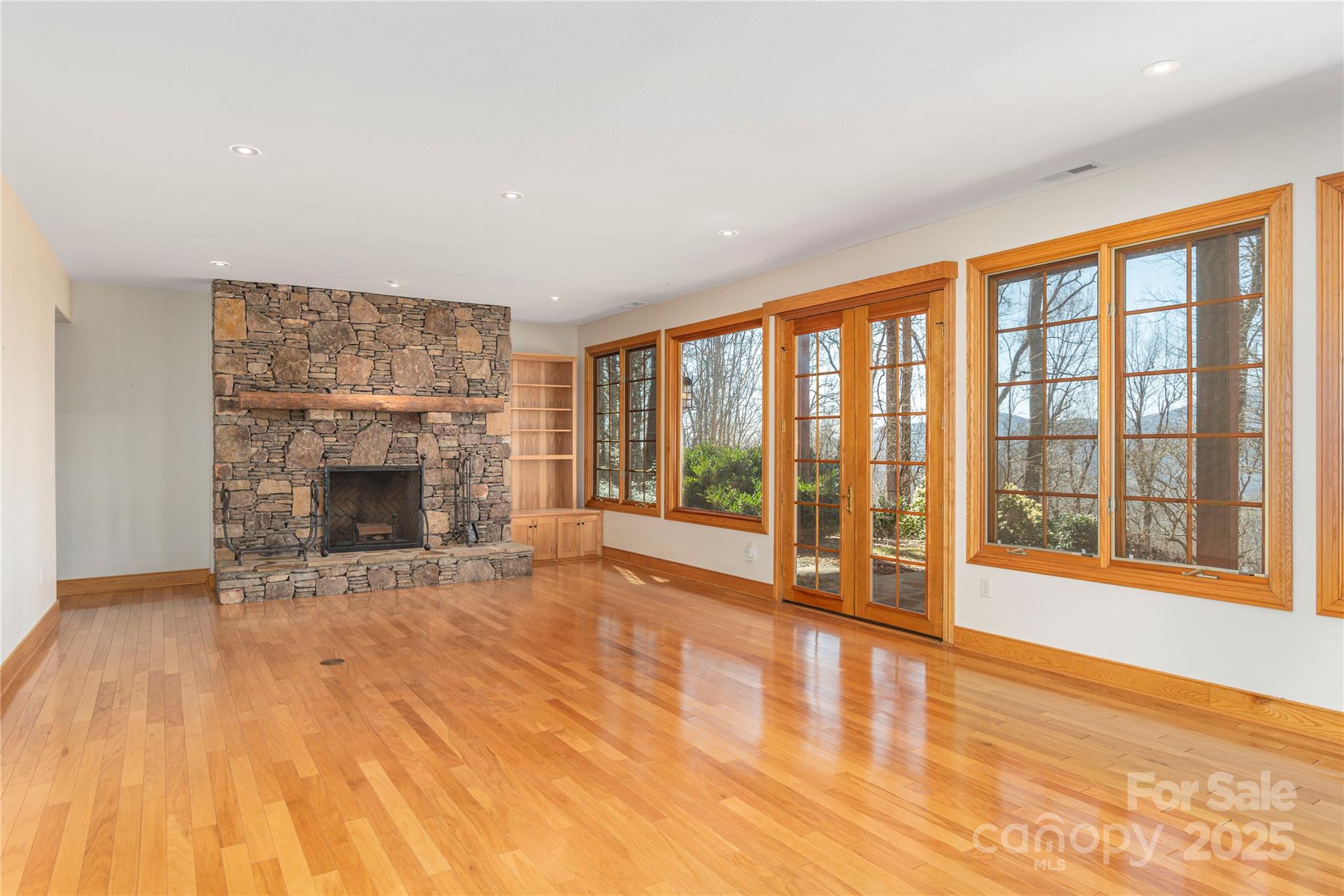 98 Flat Creek Road Fairview, NC 28730 - Photo 25 of 47 a view of an empty room with a fireplace and a window