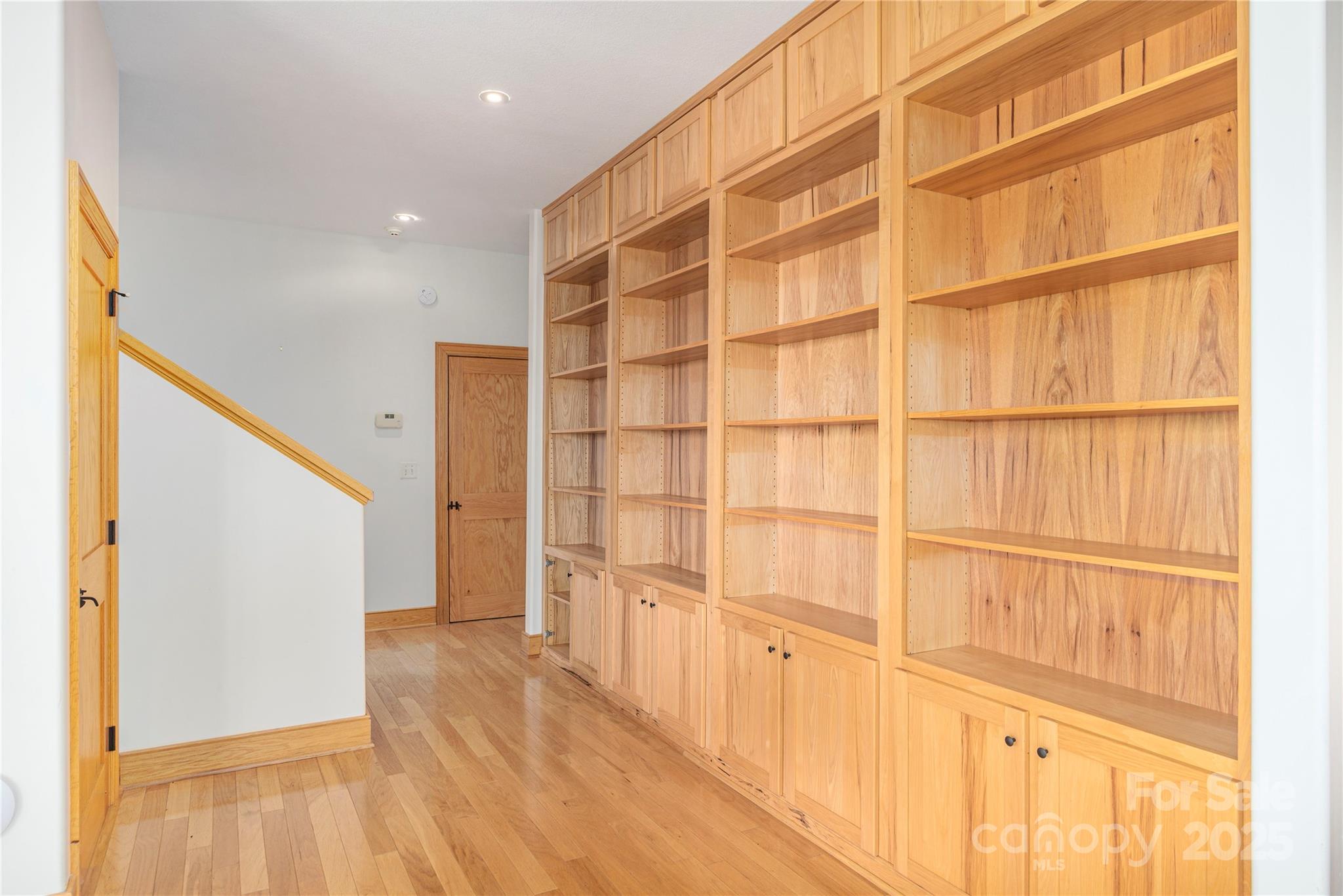 98 Flat Creek Road Fairview, NC 28730 - Photo 26 of 47 a view of an empty room with wooden floor and a window