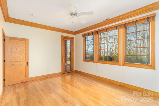 a living room with furniture and floor to ceiling windows