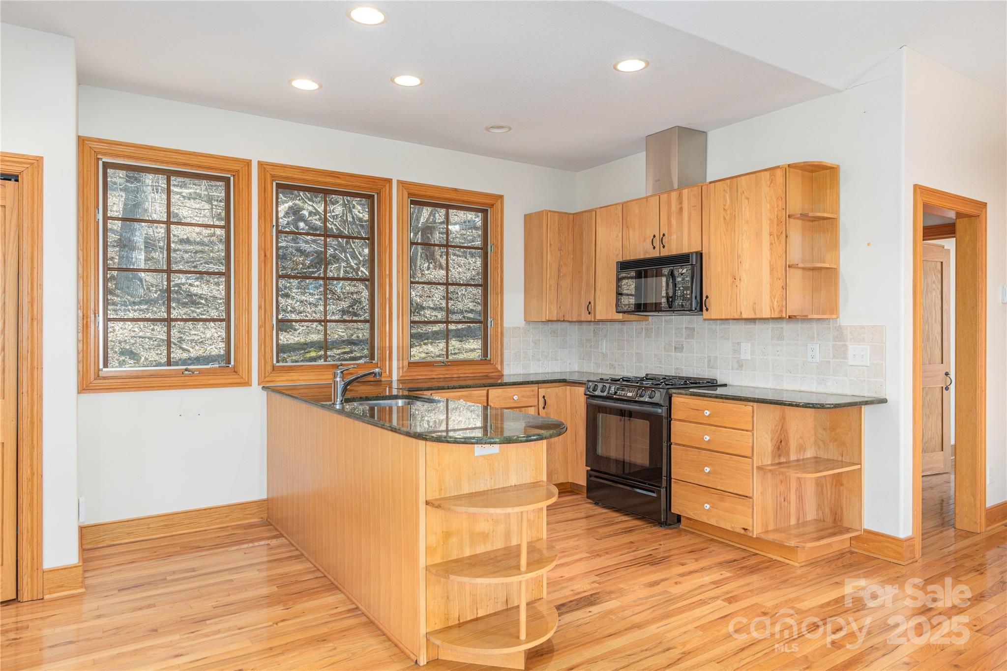 98 Flat Creek Road Fairview, NC 28730 - Photo 32 of 47 a kitchen with stainless steel appliances granite countertop a stove and a wooden cabinets