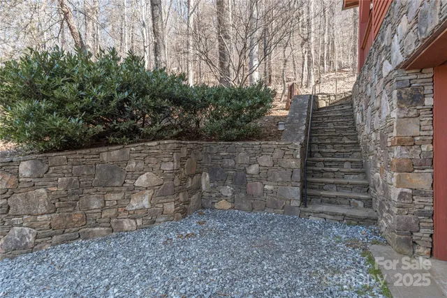 an aerial view of a house with a yard and lake view