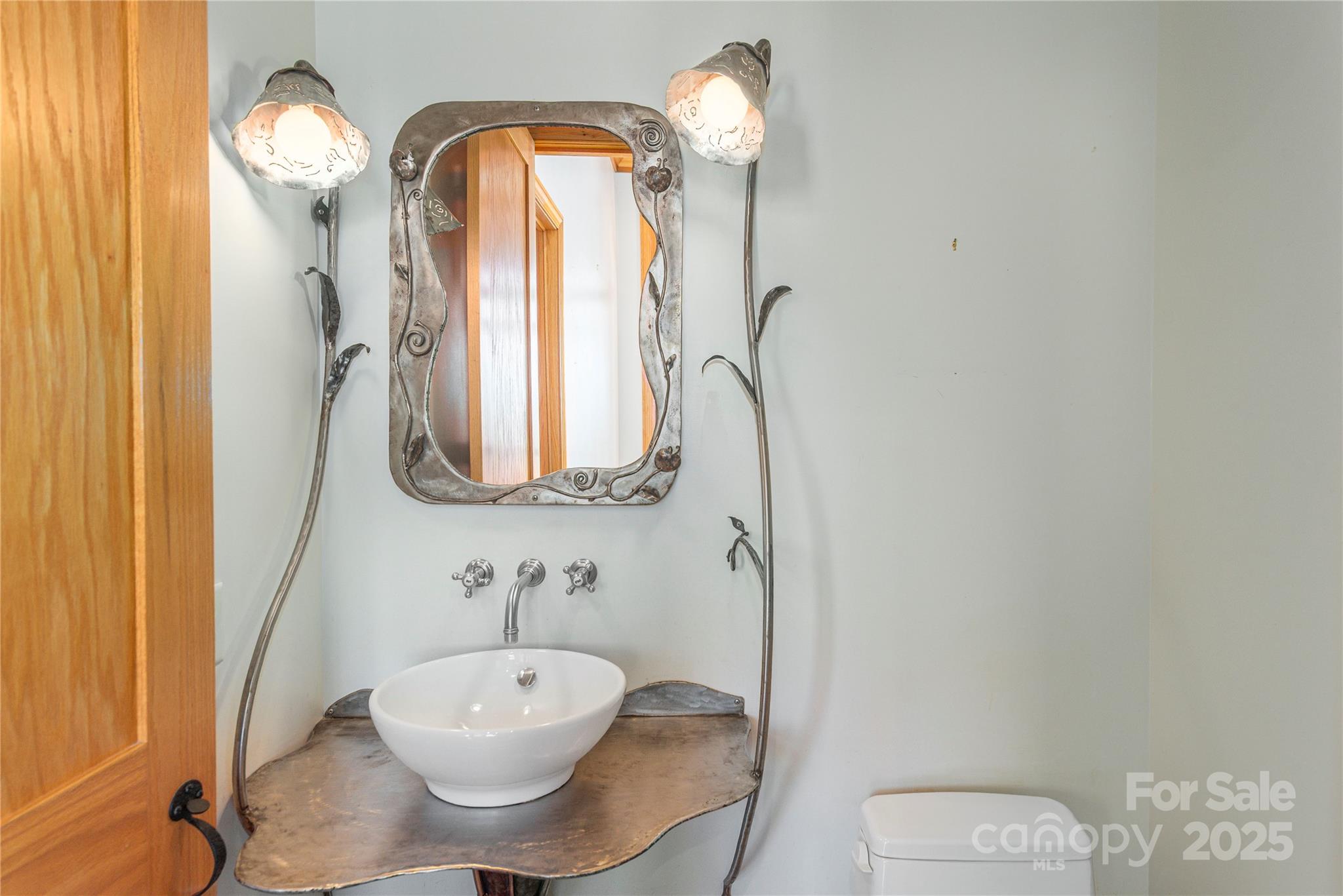 98 Flat Creek Road Fairview, NC 28730 - Photo 40 of 47 a bathroom with a toilet a sink and mirror