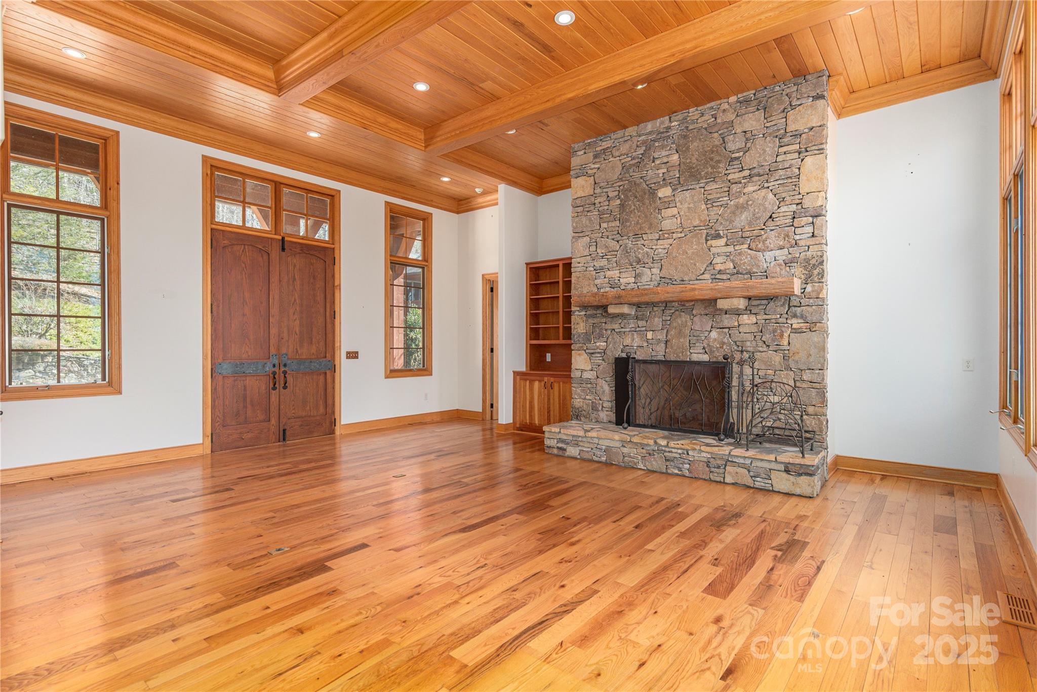 98 Flat Creek Road Fairview, NC 28730 - Photo 9 of 47 a view of an empty room with wooden floor fireplace and a window