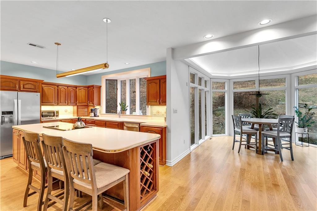 413 Windmere Drive Pittsburgh, PA 15238 - Photo 21 of 50 a dining room with stainless steel appliances granite countertop a table chairs and a wooden floor