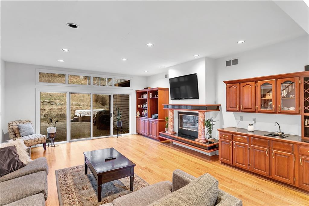 413 Windmere Drive Pittsburgh, PA 15238 - Photo 26 of 50 a living room with fireplace furniture and a flat screen tv