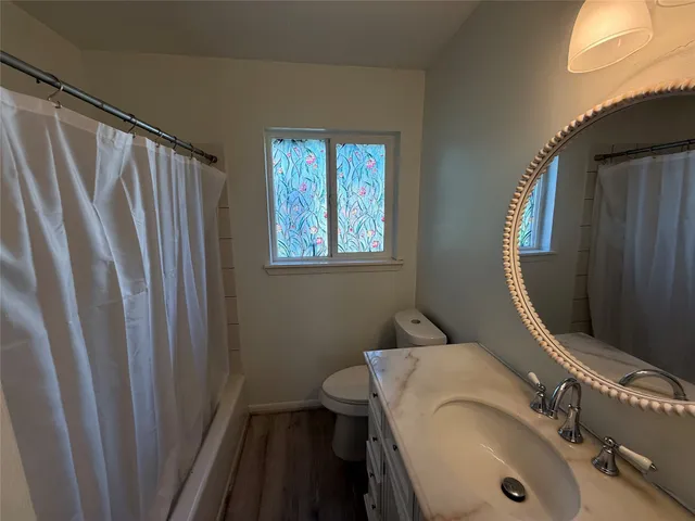 a bathroom with shower sink and mirror