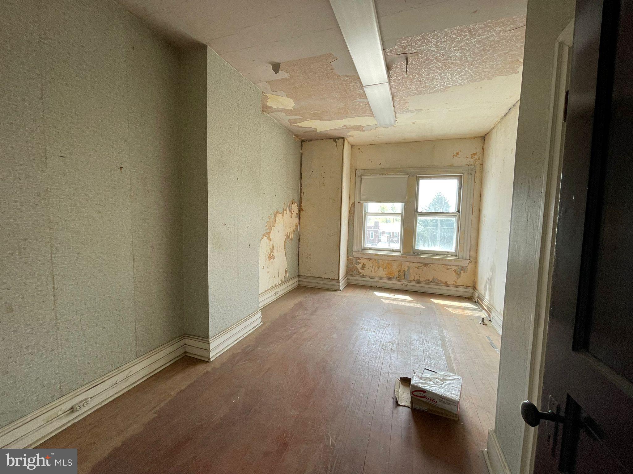 5809 Chew Avenue Philadelphia, PA 19138 - Photo 7 of 29 an empty room with wooden floor and windows