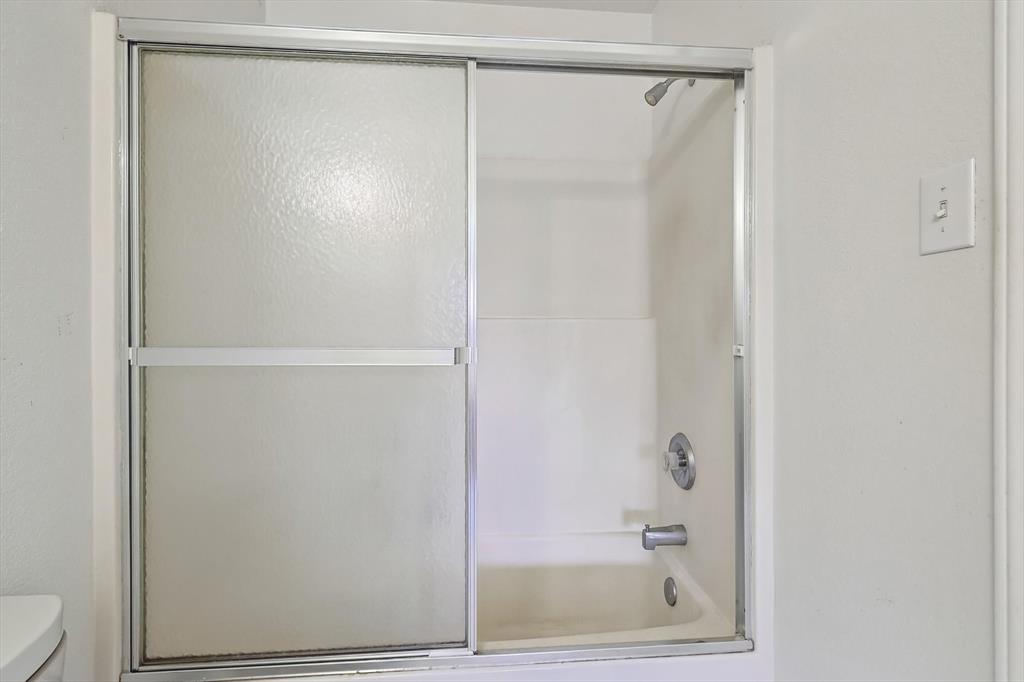 5424 Elk Ridge Drive Watauga, TX 76137 - Photo 24 of 40 a bathroom with a glass shower door